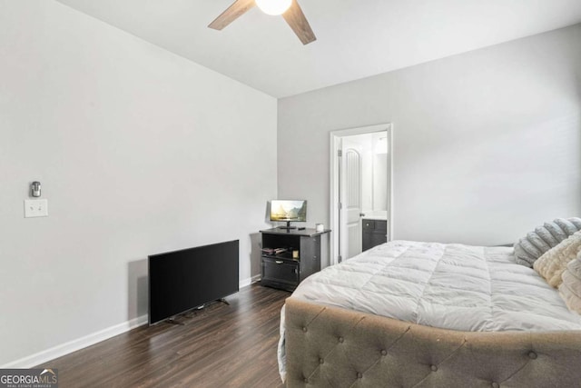 bedroom with ensuite bath, baseboards, a ceiling fan, and dark wood-style floors