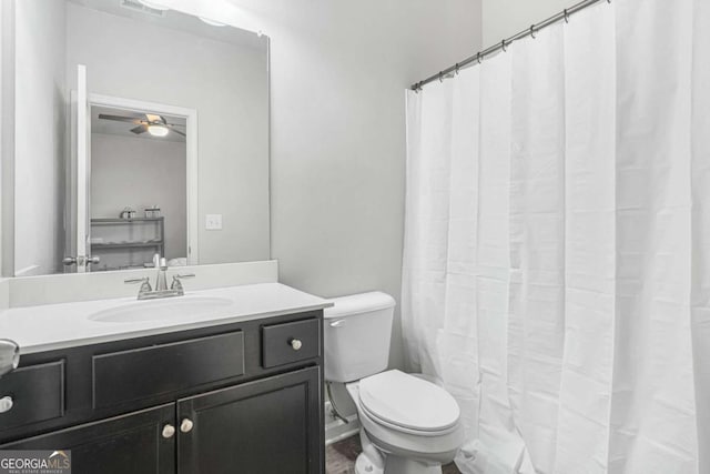 bathroom with visible vents, vanity, and toilet