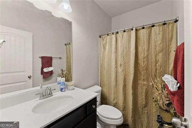 bathroom featuring vanity and toilet