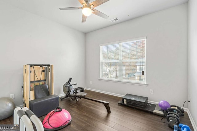 exercise area with dark wood-style flooring, visible vents, ceiling fan, and baseboards