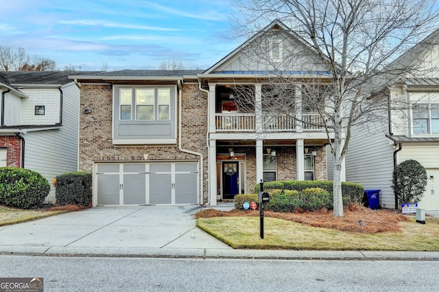 view of front of house featuring a garage, a balcony, and a front yard