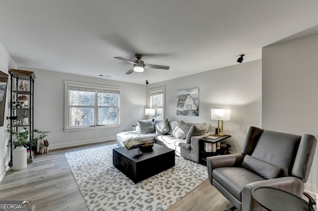 living room featuring ceiling fan and light wood-type flooring