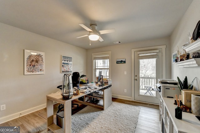 home office with ceiling fan and light wood-type flooring