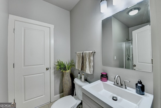 bathroom featuring toilet, vanity, and walk in shower