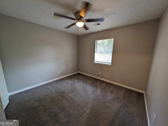 carpeted empty room featuring a textured ceiling and ceiling fan