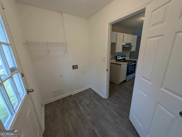 laundry area featuring dark hardwood / wood-style flooring, a textured ceiling, and hookup for a washing machine