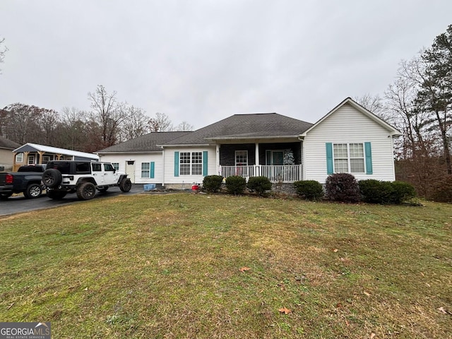 ranch-style home with covered porch and a front yard