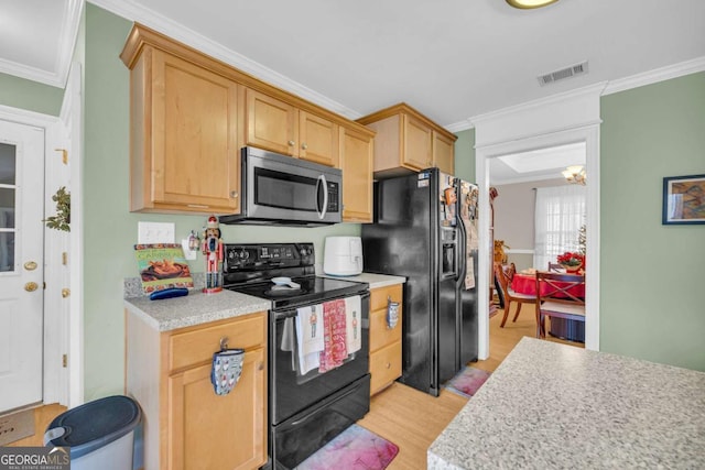 kitchen with a notable chandelier, light hardwood / wood-style floors, light brown cabinetry, black appliances, and ornamental molding