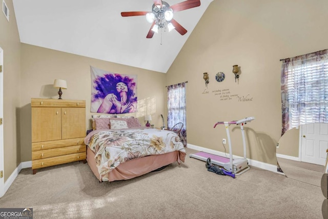 carpeted bedroom with ceiling fan and high vaulted ceiling