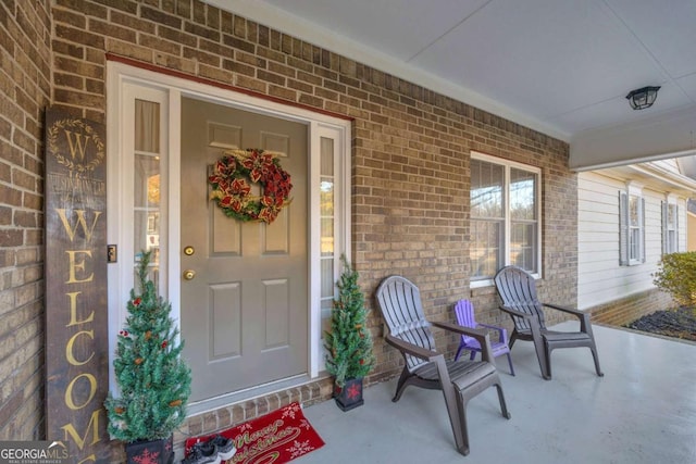 view of exterior entry featuring covered porch