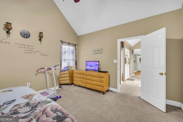 carpeted bedroom with ceiling fan and high vaulted ceiling