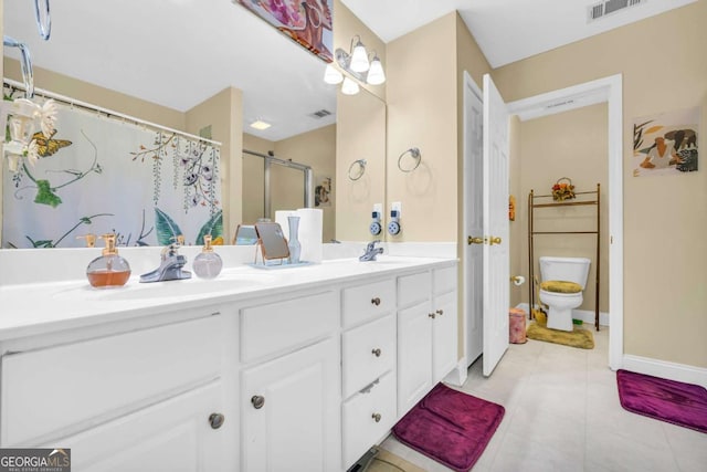 bathroom with tile patterned flooring, a shower with curtain, vanity, and toilet