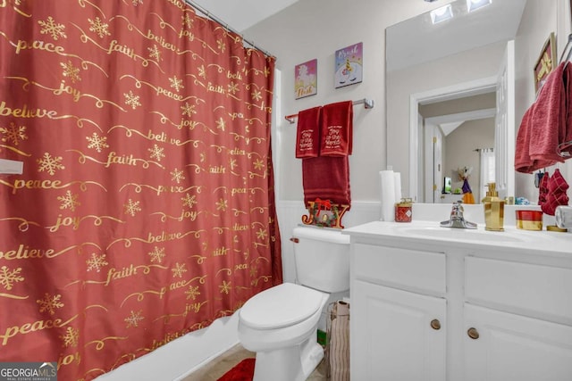 full bathroom with shower / tub combo with curtain, vanity, and toilet