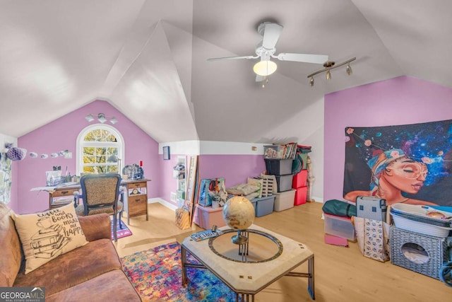 game room featuring ceiling fan, light hardwood / wood-style floors, and vaulted ceiling