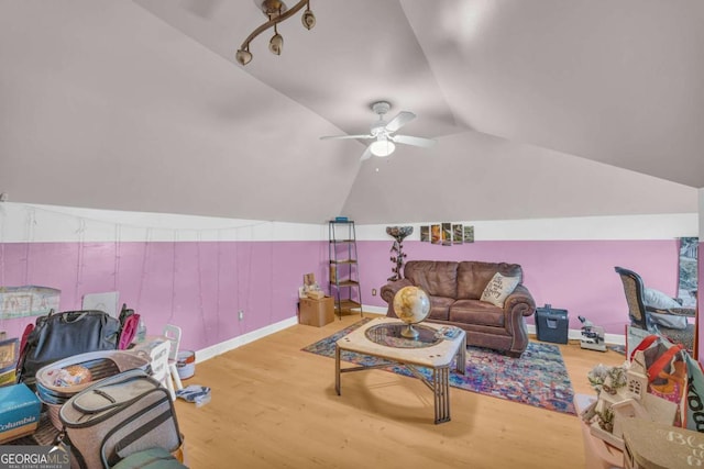 living room featuring ceiling fan, lofted ceiling, and hardwood / wood-style flooring