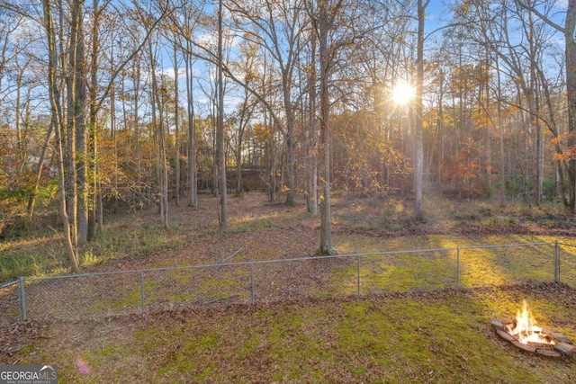 view of yard with a fire pit