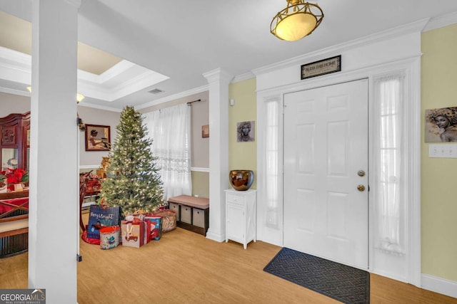 foyer entrance featuring wood-type flooring and ornamental molding