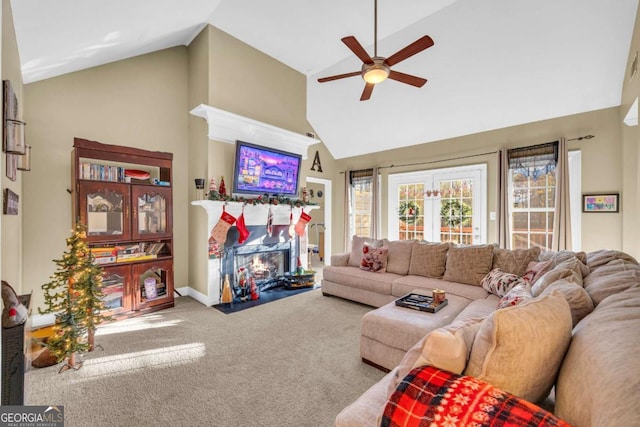 carpeted living room featuring high vaulted ceiling and ceiling fan