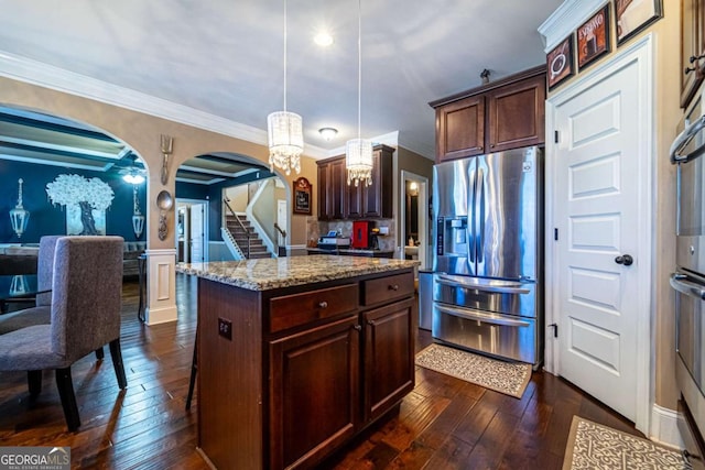 kitchen with dark hardwood / wood-style floors, a center island, pendant lighting, and stainless steel refrigerator with ice dispenser