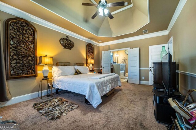 carpeted bedroom featuring a tray ceiling, ceiling fan, and ornamental molding