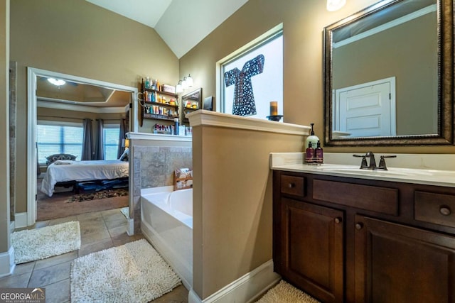 bathroom featuring a tub, tile patterned flooring, vanity, and vaulted ceiling