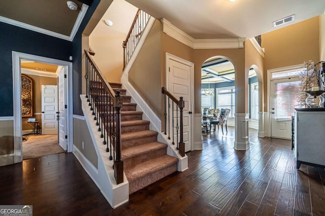 entrance foyer with dark hardwood / wood-style flooring and ornamental molding