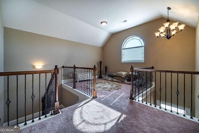 staircase with carpet flooring, lofted ceiling, and a chandelier