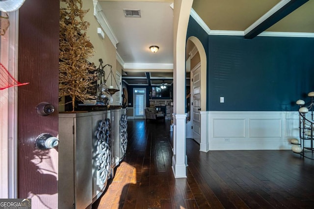 foyer with dark hardwood / wood-style flooring, ceiling fan, and ornamental molding