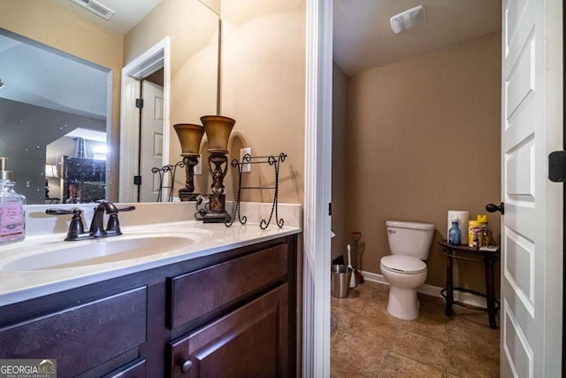 bathroom featuring tile patterned floors, vanity, and toilet