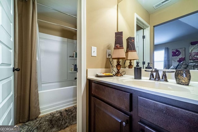 bathroom with vanity and shower / bath combo