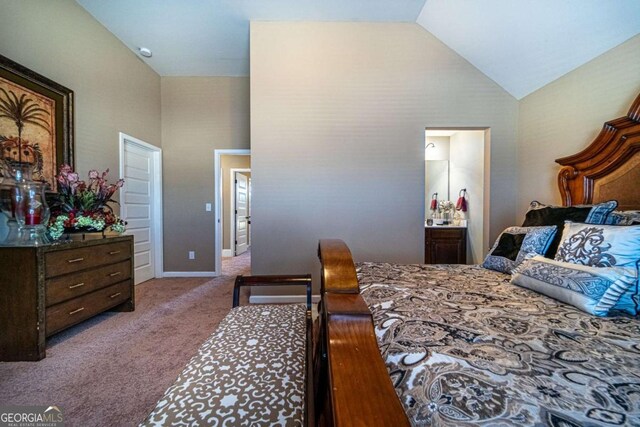 bedroom with carpet flooring, ensuite bath, and high vaulted ceiling