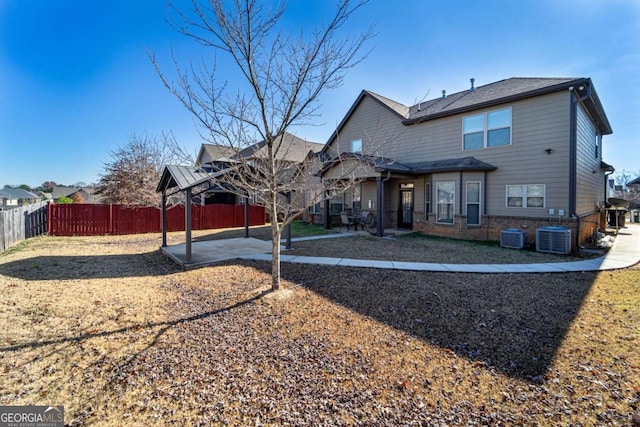 rear view of property featuring a patio area and central AC