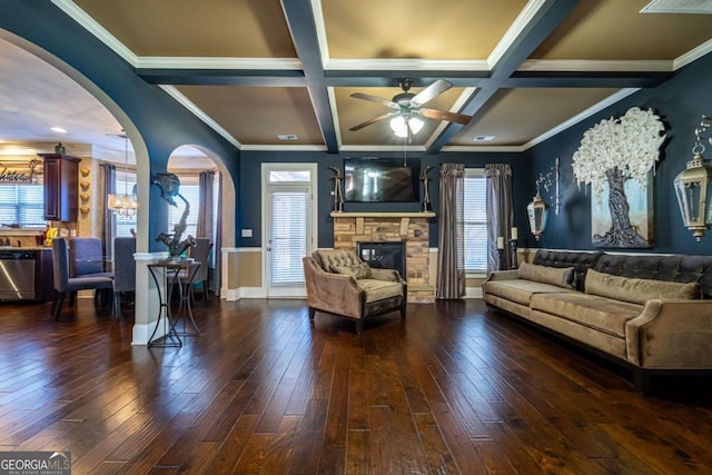 living room with a fireplace, a wealth of natural light, dark wood-type flooring, and coffered ceiling