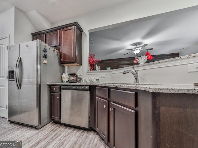 kitchen with dark brown cabinetry, stainless steel appliances, ceiling fan, sink, and light hardwood / wood-style floors