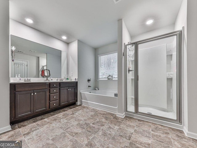 bathroom with vanity and independent shower and bath