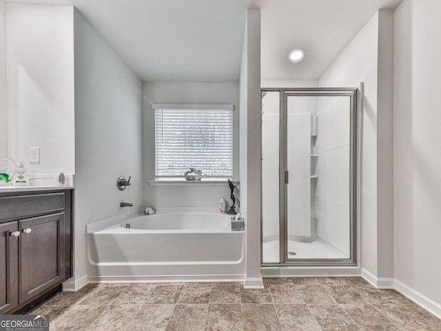 bathroom featuring vanity and shower with separate bathtub