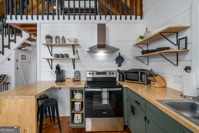 kitchen featuring wooden counters, wall chimney range hood, electric range, high vaulted ceiling, and beamed ceiling