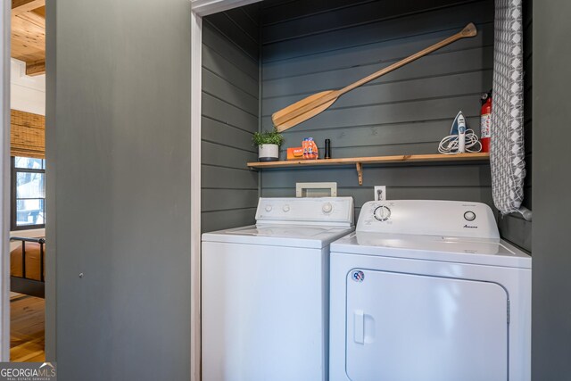 full bathroom with shower / bath combination with curtain, wood walls, and wooden ceiling