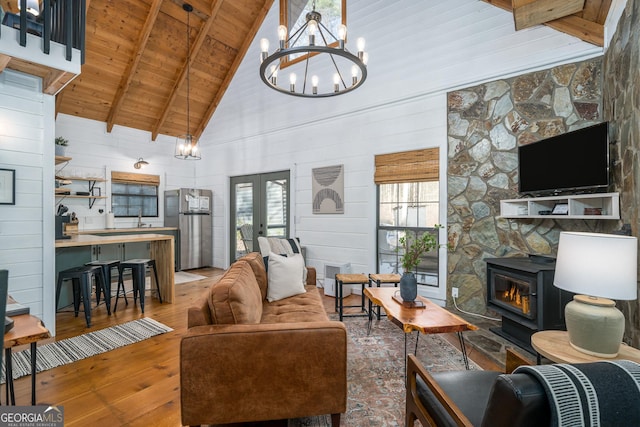 living room featuring wood ceiling, wood-type flooring, high vaulted ceiling, beamed ceiling, and wood walls