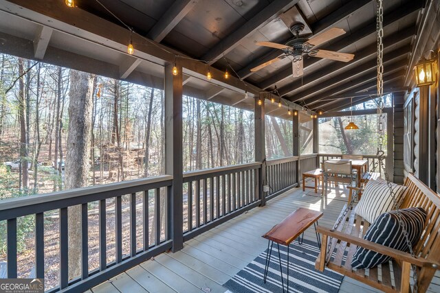 unfurnished sunroom with beam ceiling and wooden ceiling