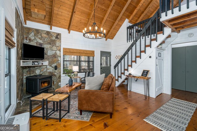 kitchen featuring wooden ceiling, exhaust hood, lofted ceiling with beams, hanging light fixtures, and appliances with stainless steel finishes