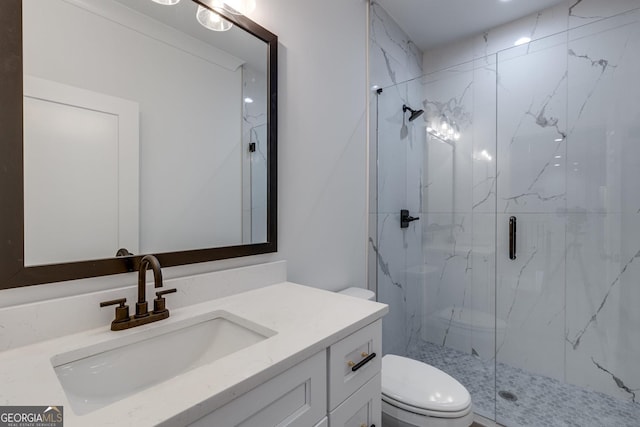 bathroom featuring vanity, toilet, and a shower with shower door