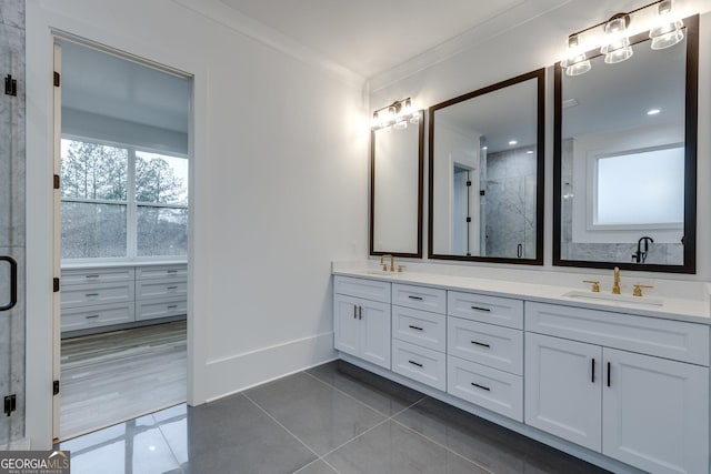 bathroom with tile patterned floors, crown molding, and vanity