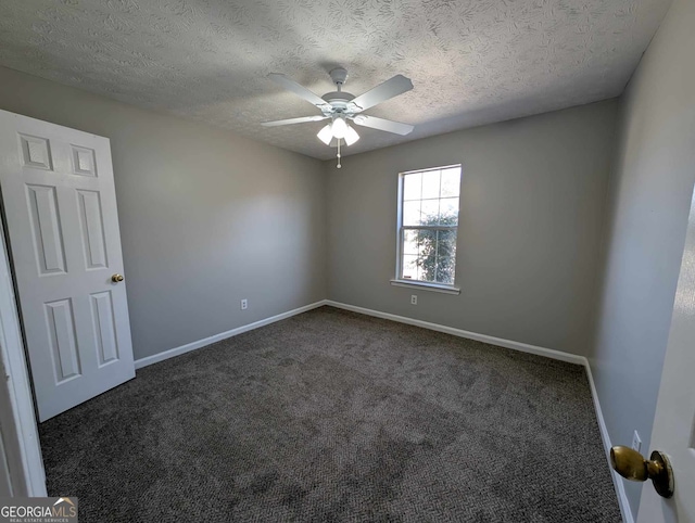 carpeted spare room featuring ceiling fan and a textured ceiling