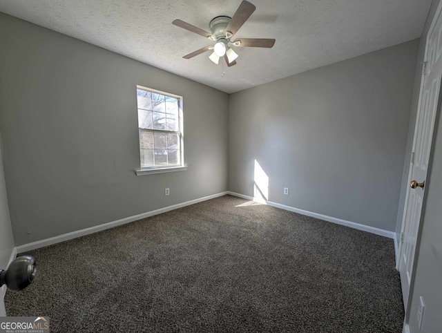 carpeted empty room with ceiling fan and a textured ceiling