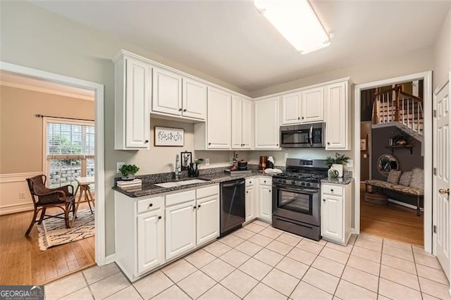 kitchen featuring white cabinets, light wood-type flooring, and stainless steel appliances