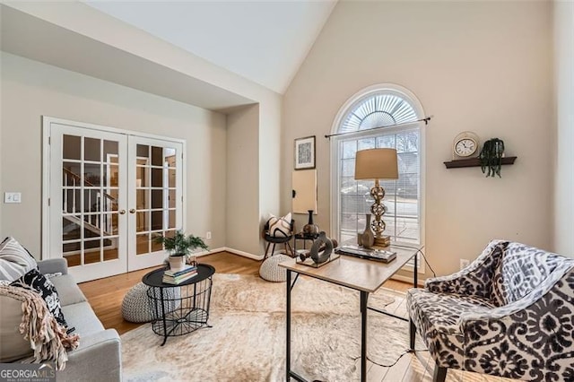 office area with french doors, high vaulted ceiling, and wood-type flooring