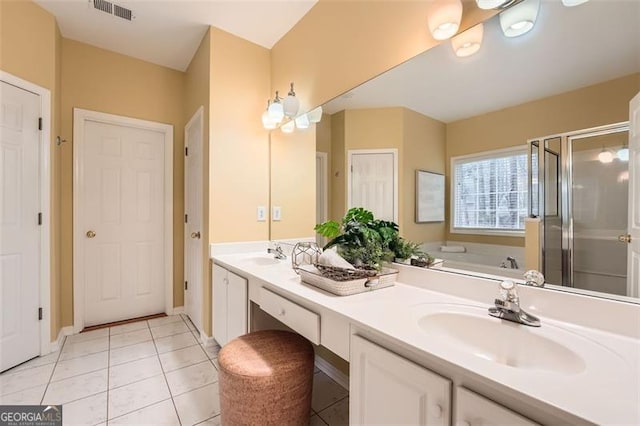 bathroom with tile patterned floors, vanity, and separate shower and tub