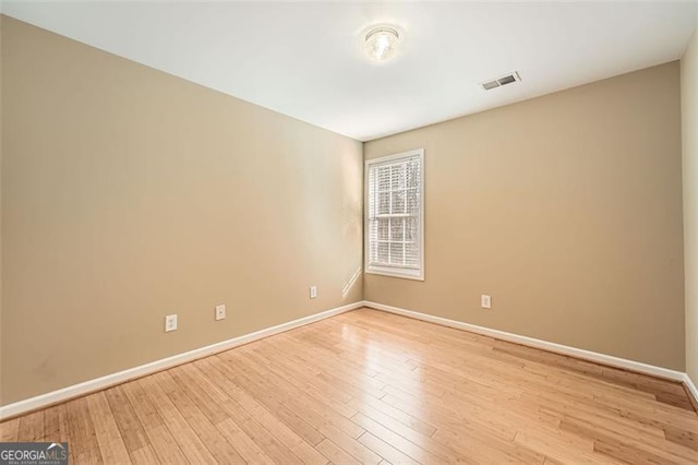 spare room with light wood-type flooring