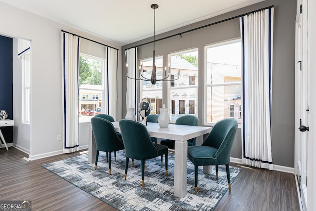 dining space featuring a notable chandelier, plenty of natural light, and dark hardwood / wood-style flooring